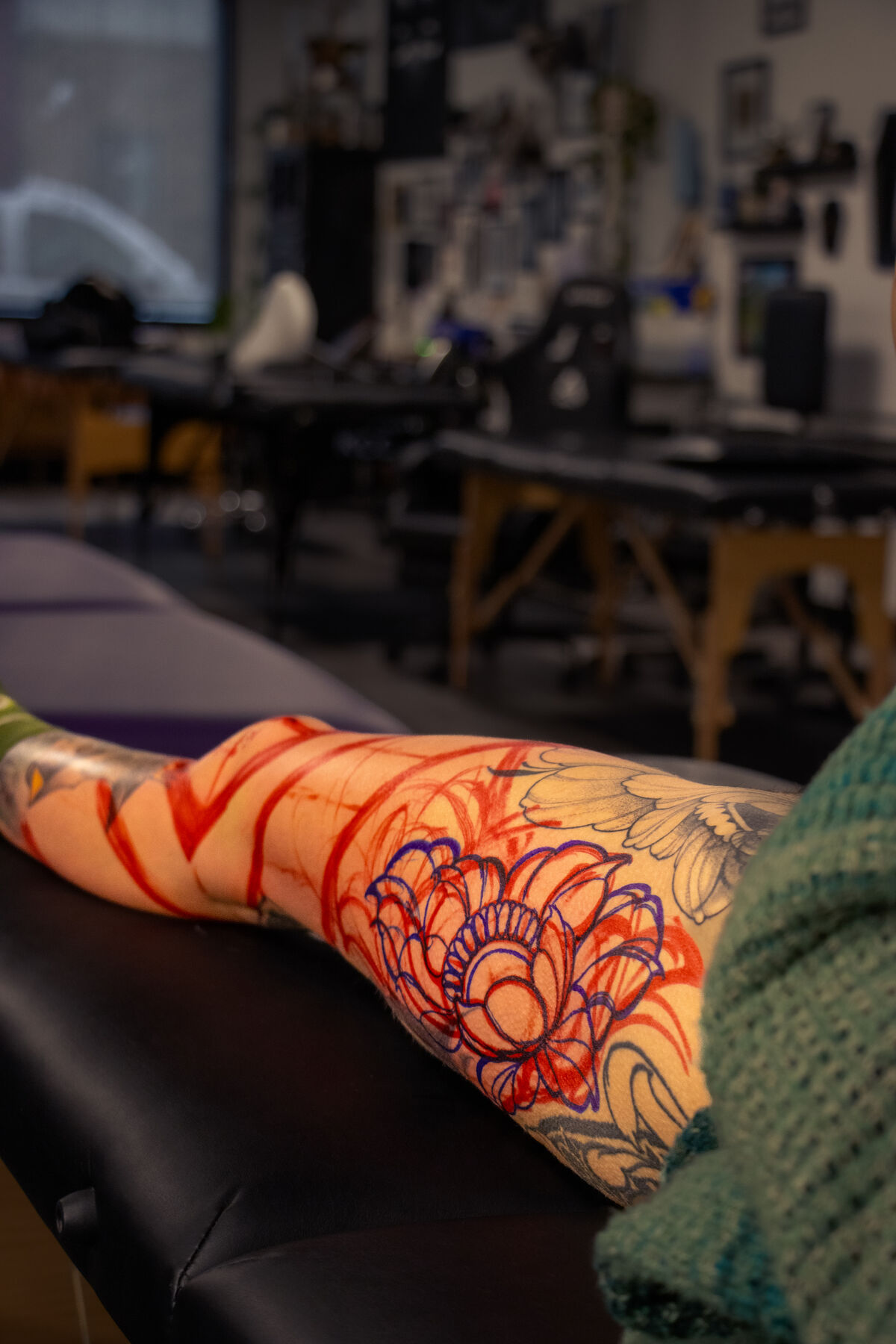 A stencilled leg on the table with the studio floor behind